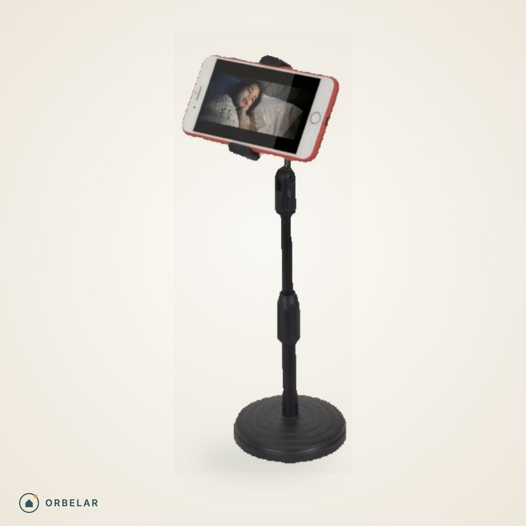 Suporte de mesa para celular preto com base redonda, segurando o celular na horizontal